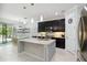 Bright and airy kitchen featuring a large island with granite countertops, black cabinets, and a dining area at 731 116Th Ne Ct, Bradenton, FL 34212