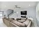Open-concept living space featuring a cozy sectional sofa and staircase to the second floor at 731 116Th Ne Ct, Bradenton, FL 34212
