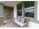 Inviting porch with a comfortable bench, neutral pillows, and stylish stone and tile accents at 731 116Th Ne Ct, Bradenton, FL 34212