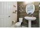 Stylishly decorated powder room features wood accent wall and pedestal sink at 731 116Th Ne Ct, Bradenton, FL 34212