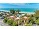Stunning aerial view showcasing the property's proximity to a beautiful beach and lush landscaping at 7324 Gulf Dr # 12, Holmes Beach, FL 34217