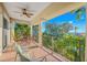 Relaxing balcony with outdoor seating overlooking lush greenery and partial ocean views at 7324 Gulf Dr # 12, Holmes Beach, FL 34217