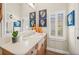 Updated bathroom with shell-themed decor and plantation shutters at 7324 Gulf Dr # 12, Holmes Beach, FL 34217