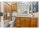 Bathroom with tiled shower, seashell art, and white orchids at 7324 Gulf Dr # 12, Holmes Beach, FL 34217