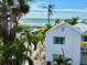 Beautiful beach view from the property surrounded with palms and vegetation with ocean in the background at 7324 Gulf Dr # 12, Holmes Beach, FL 34217