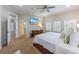 Bedroom featuring a ceiling fan, plantation shutters, TV, and a walk-in closet at 7324 Gulf Dr # 12, Holmes Beach, FL 34217