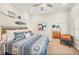 Bright bedroom with blue patterned bedding, fish art and connected bathroom view creates a relaxing getaway at 7324 Gulf Dr # 12, Holmes Beach, FL 34217
