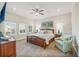 Spacious bedroom with plantation shutters, ceiling fan, and woven furniture at 7324 Gulf Dr # 12, Holmes Beach, FL 34217