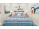 Bedroom with fish decor, lamps, and art at 7324 Gulf Dr # 12, Holmes Beach, FL 34217