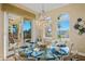Elegant dining area with glass table, chandelier, and scenic outdoor views at 7324 Gulf Dr # 12, Holmes Beach, FL 34217