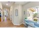 Hallway with side light windows, artwork, showing tan tile flooring, and white trim at 7324 Gulf Dr # 12, Holmes Beach, FL 34217