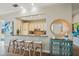Kitchen bar area with seating, countertop view into the kitchen, and decorative accents at 7324 Gulf Dr # 12, Holmes Beach, FL 34217