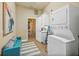 Convenient laundry room featuring a stacked washer and dryer with adjacent seating and an open doorway at 7324 Gulf Dr # 12, Holmes Beach, FL 34217