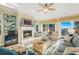 Bright living room featuring a fireplace, ceiling fan, and sliding doors with a view at 7324 Gulf Dr # 12, Holmes Beach, FL 34217