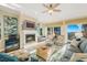 Bright living room featuring a fireplace, ceiling fan, and sliding doors with a view at 7324 Gulf Dr # 12, Holmes Beach, FL 34217