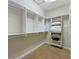 A clean and well organized walk-in closet with shelves and hanging bars at 7324 Gulf Dr # 12, Holmes Beach, FL 34217