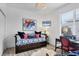 Stylish bedroom area features a bed, decor, and a desk with a chair at 7904 Hampton Ct, University Park, FL 34201