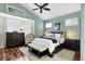 Tranquil bedroom with a tray ceiling and well-lit windows, plus dark wood floors at 7904 Hampton Ct, University Park, FL 34201