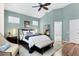 Calm bedroom with light-blue walls, a tray ceiling, and access to the ensuite bathroom at 7904 Hampton Ct, University Park, FL 34201