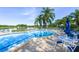 Community pool area with lake views and plenty of lounge seating at 7904 Hampton Ct, University Park, FL 34201