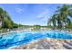 Community pool offers lake views and a relaxing spot to unwind at 7904 Hampton Ct, University Park, FL 34201