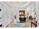 Elegant foyer with a decorative door, hardwood floors, console table, and an ornate chandelier at 7904 Hampton Ct, University Park, FL 34201