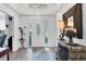 Bright foyer with an oval glass door, elegant decor, mirror, and striking light fixture at 7904 Hampton Ct, University Park, FL 34201