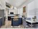 Bright kitchen with modern appliances, large island with storage, and light, wood-style flooring at 7904 Hampton Ct, University Park, FL 34201