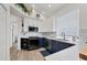 Well-lit kitchen featuring white and blue cabinets and stainless steel appliances at 7904 Hampton Ct, University Park, FL 34201