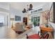 Open-concept living room with a unique fan, large windows, stylish furniture, and modern decor at 7904 Hampton Ct, University Park, FL 34201