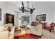 Spacious living room with a fan, modern furniture, and sliding doors leading to the outdoors at 7904 Hampton Ct, University Park, FL 34201