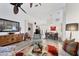Bright open-concept living room featuring hardwood floors, a fan, and elegant decor at 7904 Hampton Ct, University Park, FL 34201