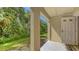 Cozy back porch with a view of the backyard and the surrounding trees offers a relaxing spot to unwind at 8823 White Sage Loop # 1802, Lakewood Ranch, FL 34202