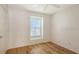 Bedroom featuring hardwood floors, a window, and white walls at 8823 White Sage Loop # 1802, Lakewood Ranch, FL 34202