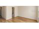 Bright bedroom featuring wood floors, a bathroom, and light colored walls at 8823 White Sage Loop # 1802, Lakewood Ranch, FL 34202