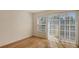Bright bedroom with hardwood floors, a large window, and sliding glass doors to a balcony at 8823 White Sage Loop # 1802, Lakewood Ranch, FL 34202