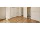 Spacious bedroom with wood floors leading to the bathroom and a closet at 8823 White Sage Loop # 1802, Lakewood Ranch, FL 34202