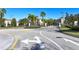 A community entrance features well-maintained streets, sidewalks, and lush landscaping at 8823 White Sage Loop # 1802, Lakewood Ranch, FL 34202