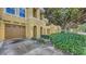Charming townhome featuring a private garage, arched entryway, and manicured landscaping at 8823 White Sage Loop # 1802, Lakewood Ranch, FL 34202
