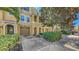 Well-maintained townhome exterior showcasing a private garage, stone accents, and lush landscaping at 8823 White Sage Loop # 1802, Lakewood Ranch, FL 34202