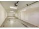 The garage has ample space for storage and vehicles with a roll up style door and bright overhead lighting at 8823 White Sage Loop # 1802, Lakewood Ranch, FL 34202