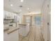 Open kitchen with an island, tile floors, white cabinets, and stainless steel appliances at 8823 White Sage Loop # 1802, Lakewood Ranch, FL 34202
