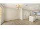 Open-concept space with kitchen access and natural light through sliding glass doors at 8823 White Sage Loop # 1802, Lakewood Ranch, FL 34202