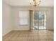 Bright living space with tile flooring, a sliding door to the patio and blinds at 8823 White Sage Loop # 1802, Lakewood Ranch, FL 34202