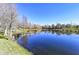 Scenic pond with trees and blue sky with a view of the community buildings in the distance at 8823 White Sage Loop # 1802, Lakewood Ranch, FL 34202