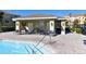 A covered seating area next to the pool provides shade and seating for residents at 8823 White Sage Loop # 1802, Lakewood Ranch, FL 34202