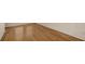 Image shows a room with a newly-installed wood floor and freshly painted white walls at 8823 White Sage Loop # 1802, Lakewood Ranch, FL 34202