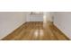 Image shows a bright room with a newly-installed wood floor and freshly painted white walls at 8823 White Sage Loop # 1802, Lakewood Ranch, FL 34202