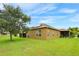 Spacious backyard with lush lawn, mature trees, and a charming covered patio at 2819 47Th E St, Palmetto, FL 34221