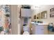 Well-lit bathroom with white cabinetry, a decorative shower curtain, and ample counter space at 2819 47Th E St, Palmetto, FL 34221